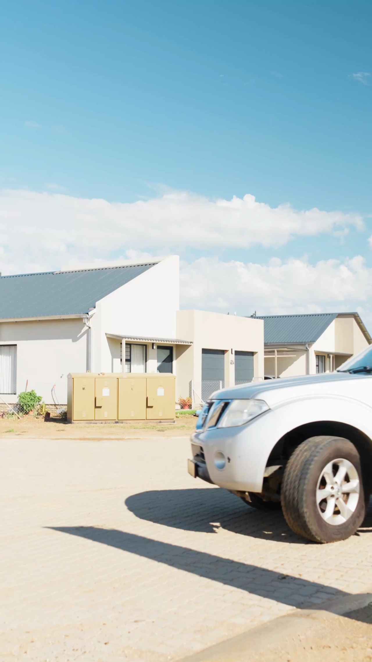 A street of new Okamita Properties homes on a clear day